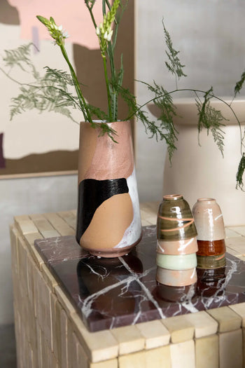 The HKLIVING Hand Painted Ceramic Flower Vase stands tall with green stems and white flowers beside two smaller vases on a marble-topped table, set against modern decor and a subtle abstract painting.