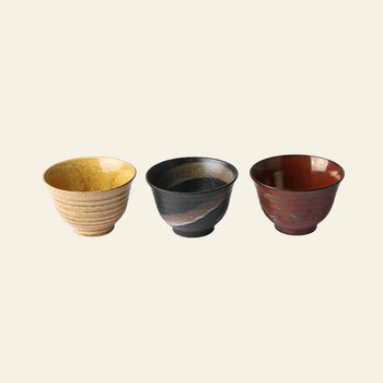 The HKLIVING Kyoto Ceramics: Japanese Matcha Bowls, Set of 3 features hand-finished bowls—yellow with ridges, black with a matte striped design, and dark brown with a glossy marbled finish—by HKLIVING, inspired by traditional Kyoto ceramics.