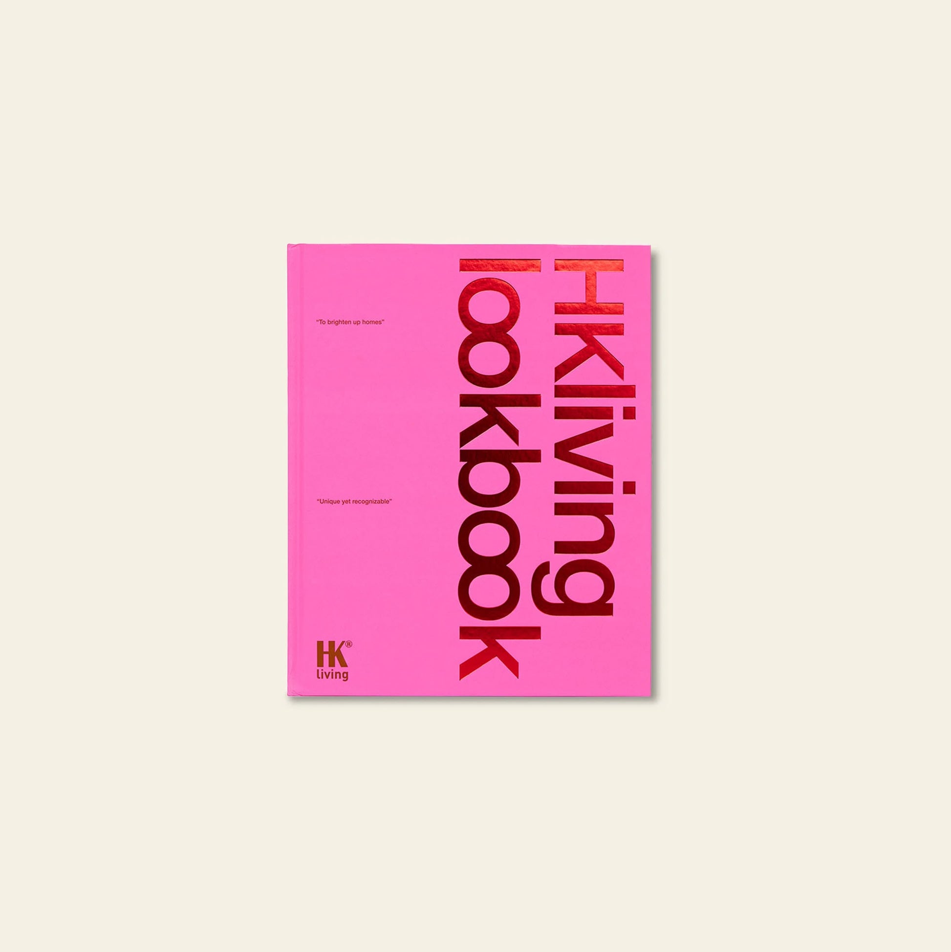 The HKLIVING Limited Edition Lookbook '22 is a pink hardcover coffee table book by HKLIVING, with bold red and black vertical text on a light beige cover and striking visuals inside.