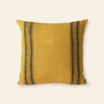 The HKliving Linen Cushion by HKliving is a square, mustard-colored linen piece with two vertical black stripes near each edge, making it a stylish decor accent against a plain light background.