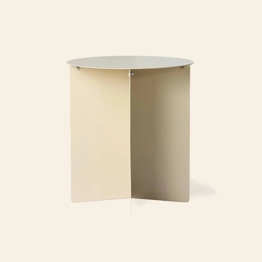 The HKLIVING Metal Side Table Round features a minimalist, modern design with a flat circular top and intersecting X-shaped base in light beige, by HKLIVING, shown against a plain background.