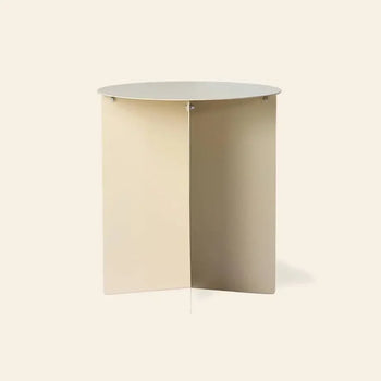 The HKLIVING Metal Side Table Round features a minimalist, modern design with a flat circular top and intersecting X-shaped base in light beige, by HKLIVING, shown against a plain background.