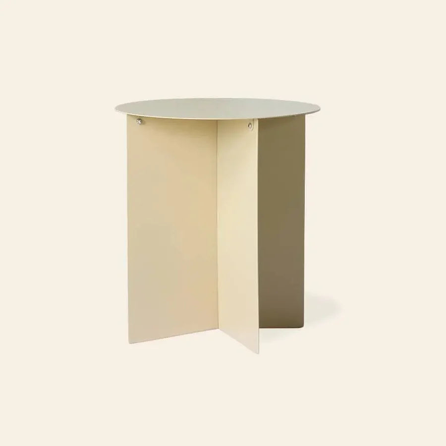 The HKLIVING Metal Side Table Round by HKLIVING features a minimalist beige design with a flat top and three intersecting vertical panels as its base, shown against a plain light background.