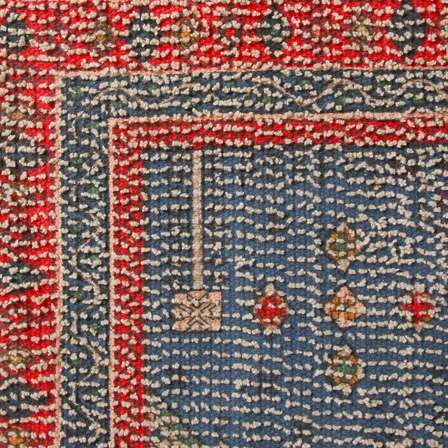 Close-up of the HKLIVING Printed Bathmat Overtufted by HKLIVING, showcasing a blue background with colorful geometric shapes, a red diamond- and dot-adorned border, visible woven texture, and an anti-slip backing.