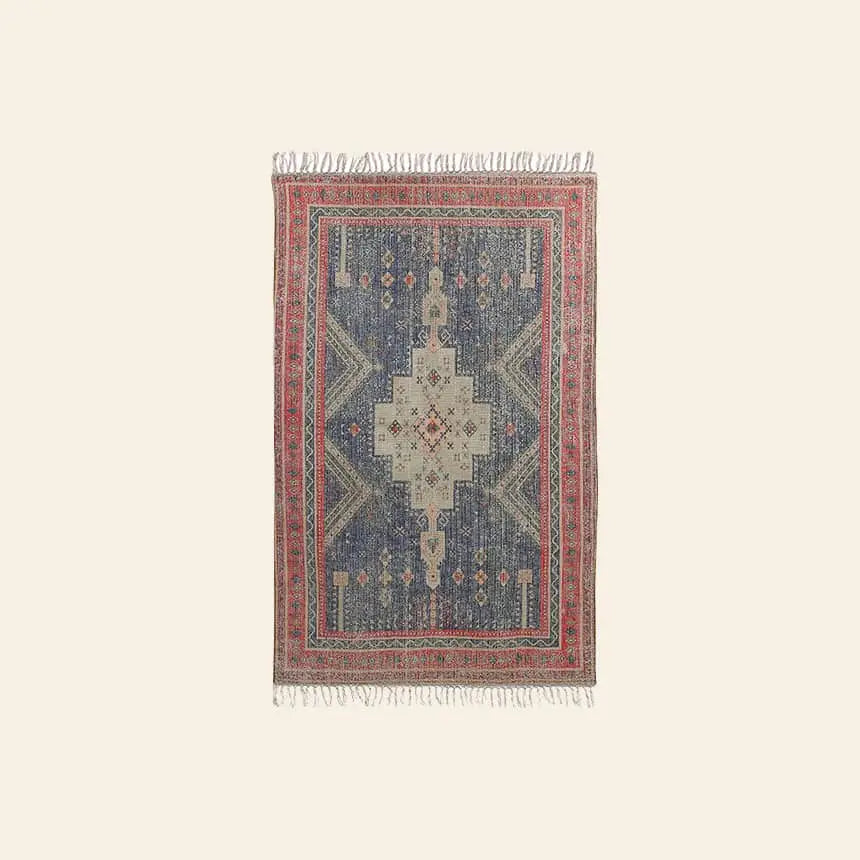 The HKLIVING Printed Rug Overtufted (150x240) by HKLIVING is a rectangular area rug with anti-slip backing, featuring red and blue geometric patterns, intricate designs, fringed edges, and a decorative border on a light background.