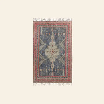 The HKLIVING Printed Rug Overtufted (150x240) by HKLIVING is a rectangular area rug with anti-slip backing, featuring red and blue geometric patterns, intricate designs, fringed edges, and a decorative border on a light background.