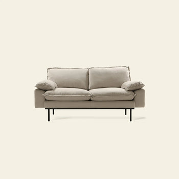 The HKLIVING Retro Sofa, 2-Seats by HKLIVING features plush cushions and slim black metal legs, offering modern vintage style. Shown here against a plain off-white background.