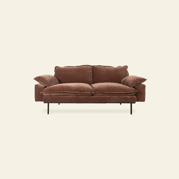 The HKLIVING Retro Sofa, 2-Seats by HKLIVING is a brown, plush vintage-inspired sofa with overstuffed cushions and slim black metal legs, featured against a plain off-white background.