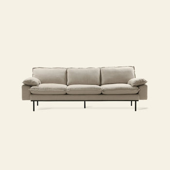 The HKLIVING Retro Sofa, 4-Seats by HKLIVING features a modern light beige design with plush cushions, slim armrests, and black metal legs, showcased against a plain off-white background.