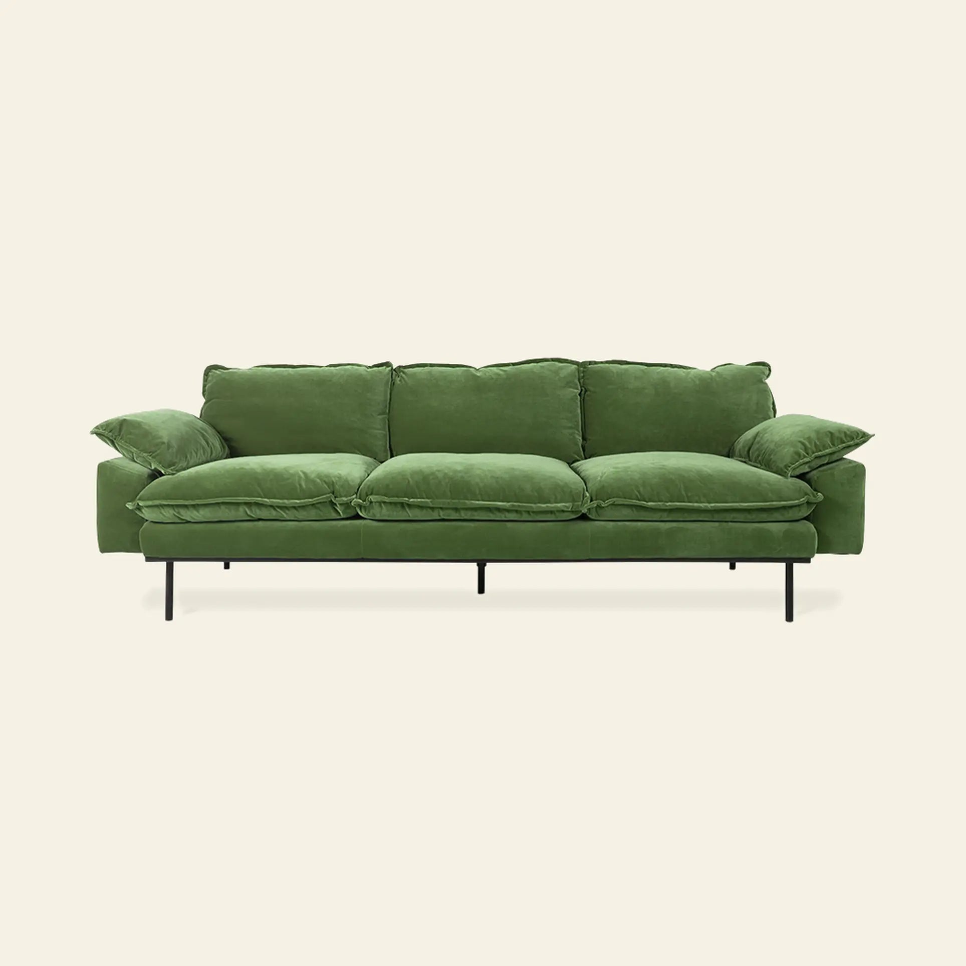 The HKLIVING Retro Sofa, 4-seats by HKLIVING features green velvet upholstery, plush cushions, and slim black metal legs, shown against a plain light beige background.