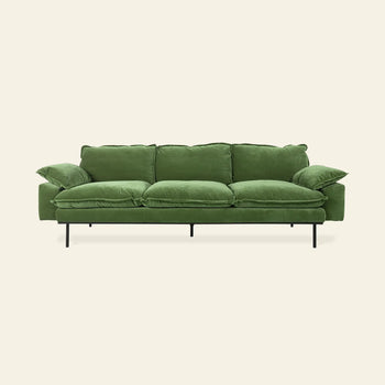 The HKLIVING Retro Sofa, 4-seats by HKLIVING features green velvet upholstery, plush cushions, and slim black metal legs, shown against a plain light beige background.