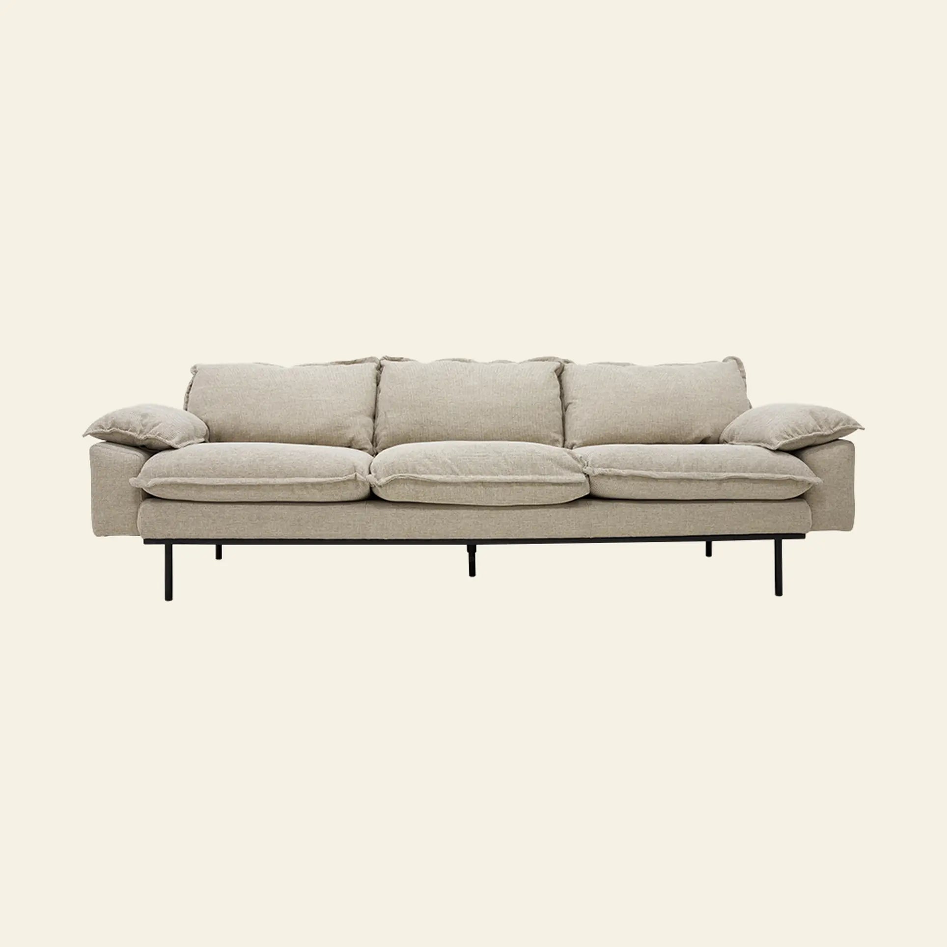 The HKLIVING Retro Sofa, 4-Seats by HKLIVING is a modern light beige sofa with four seat cushions, plush armrests, vintage style, minimalist design, and thin black metal legs. It is shown against a plain off-white background.