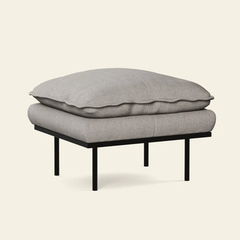 The HKLIVING Retro Sofa Hocker features a soft light gray cushion and slim black metal legs, set against a plain off-white background. This ottoman perfectly complements any HKLIVING or retro sofa setup.