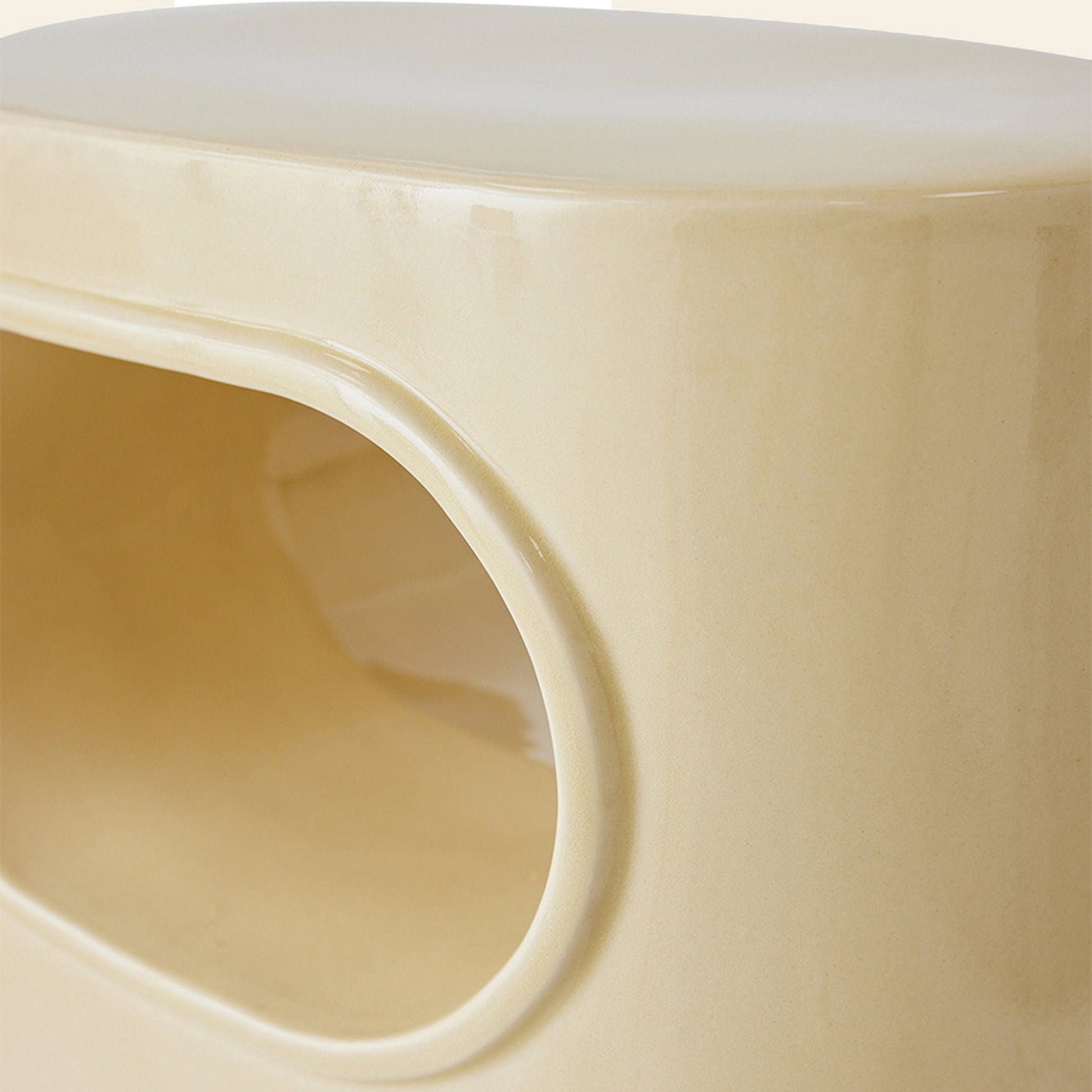 Close-up of the HKLIVING Space Side Table by HKLIVING, featuring a smooth, glossy beige ceramic finish with a rounded rectangular opening for built-in storage and a sleek modern, minimalist design—ideal for contemporary spaces.