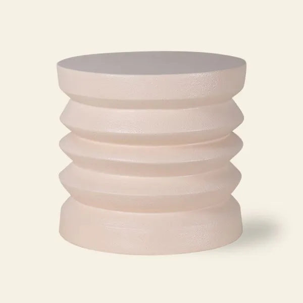 The HKLIVING Stoneware Side Table features a round, light beige stoneware body with a ribbed, stacked design and smooth top, offering durability and style from the brand HKLIVING.