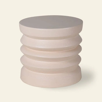 The HKLIVING Stoneware Side Table by HKLIVING features a cylindrical, light beige design with a smooth round top and grooved tiered sides, crafted from durable stoneware and displayed against an off-white background.