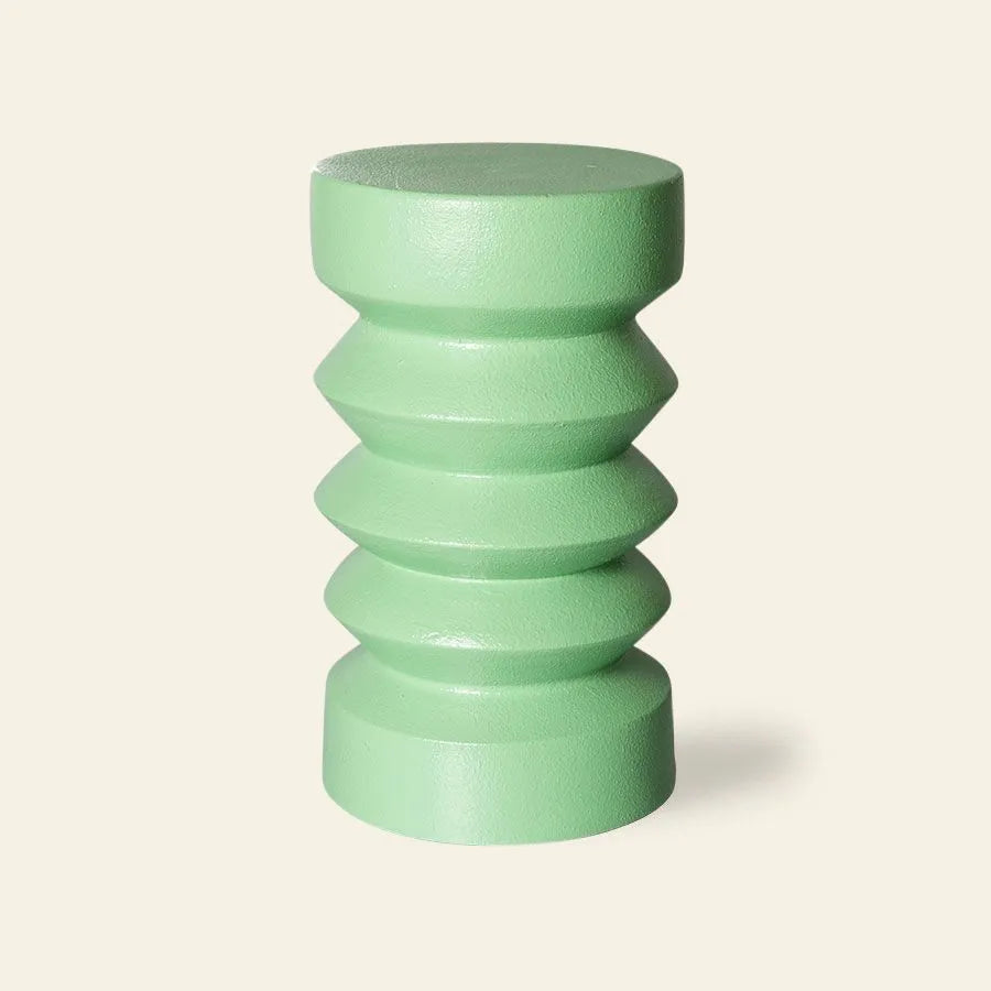 The HKLIVING Stoneware Side Table features a light green finish, rounded top, geometric zigzag midsection, and cylindrical base, displayed against a plain beige background.