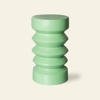 The HKLIVING Stoneware Side Table features a light green finish, rounded top, geometric zigzag midsection, and cylindrical base, displayed against a plain beige background.