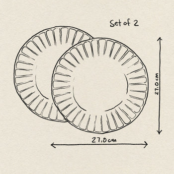 A sketch shows two overlapping HKliving The Emeralds Ceramic Dinner Plates (Set of 2), each labeled with a 27.0 cm diameter. Featuring ribbed edges, these HKliving plates are great for small meals, set against a textured background.