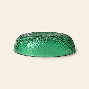 An HKliving The Emeralds: Glass Dessert Bowl by HKliving is displayed upside down on a light beige background, showcasing its rippled, grass-like texture for a modern, elegant look.