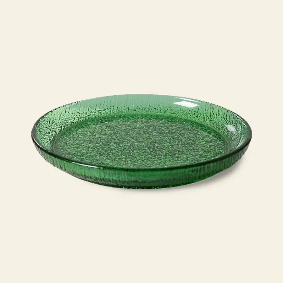 The HKliving The Emeralds: Glass Side Plate features a round, textured emerald green design with raised edges—ideal for stylish dinner parties. Displayed on a plain light background.