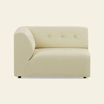 The HKLIVING Vint Couch, Left, 1.5-Seat by HKLIVING is a modern light beige upholstered corner sofa section with a low backrest, three tufted buttons, and clean lines—perfect for adaptable living and customizable setups.