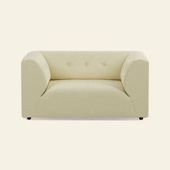 The HKLIVING Vint Couch Loveseat by HKLIVING features a modern, cream upholstery, boxy silhouette, low arms, three tufted back buttons, and short black legs, shown against a plain beige background.