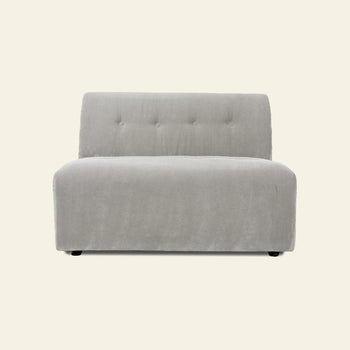 The HKLIVING Vint Couch, Middle, 1.5-Seat by HKLIVING is a modern, armless light gray upholstered chair with a tufted backrest and wide cushioned seat, designed for modular sofa configurations. Shown against an off-white background.
