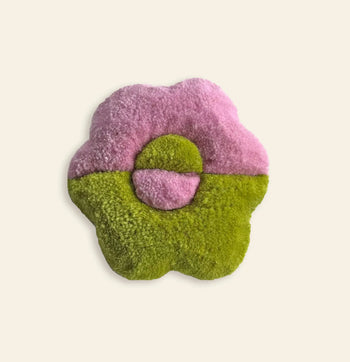 The Habichl Tufted Coasters by Habichl feature a plush flower shape with a pink top half, green bottom half, and a unique tufted design. The center circle splits the same colors, all set against a plain light background.