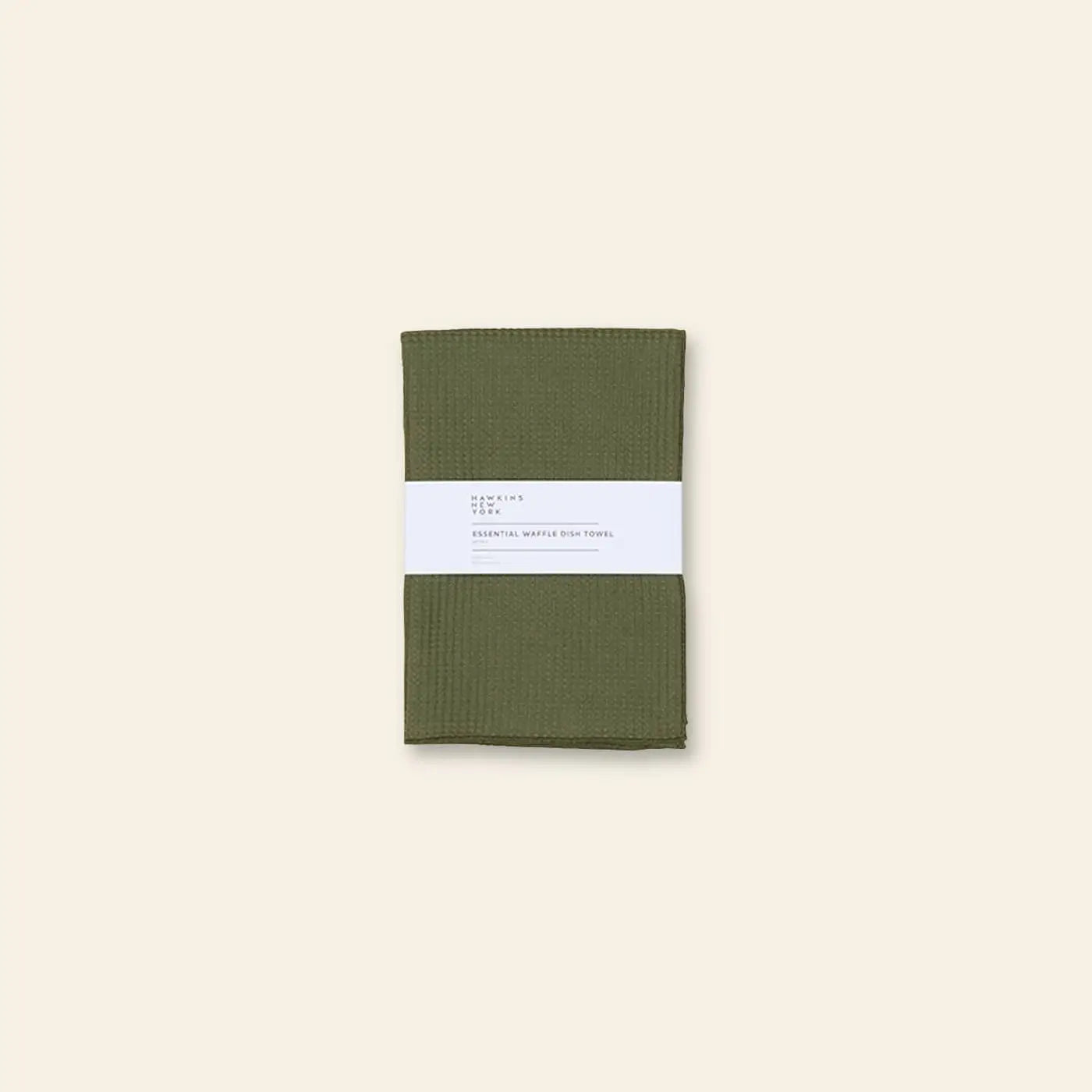 A pair of olive green Hawkins New York Essential Waffle Dish Towels, neatly folded with a white paper band, are displayed against a plain beige background.