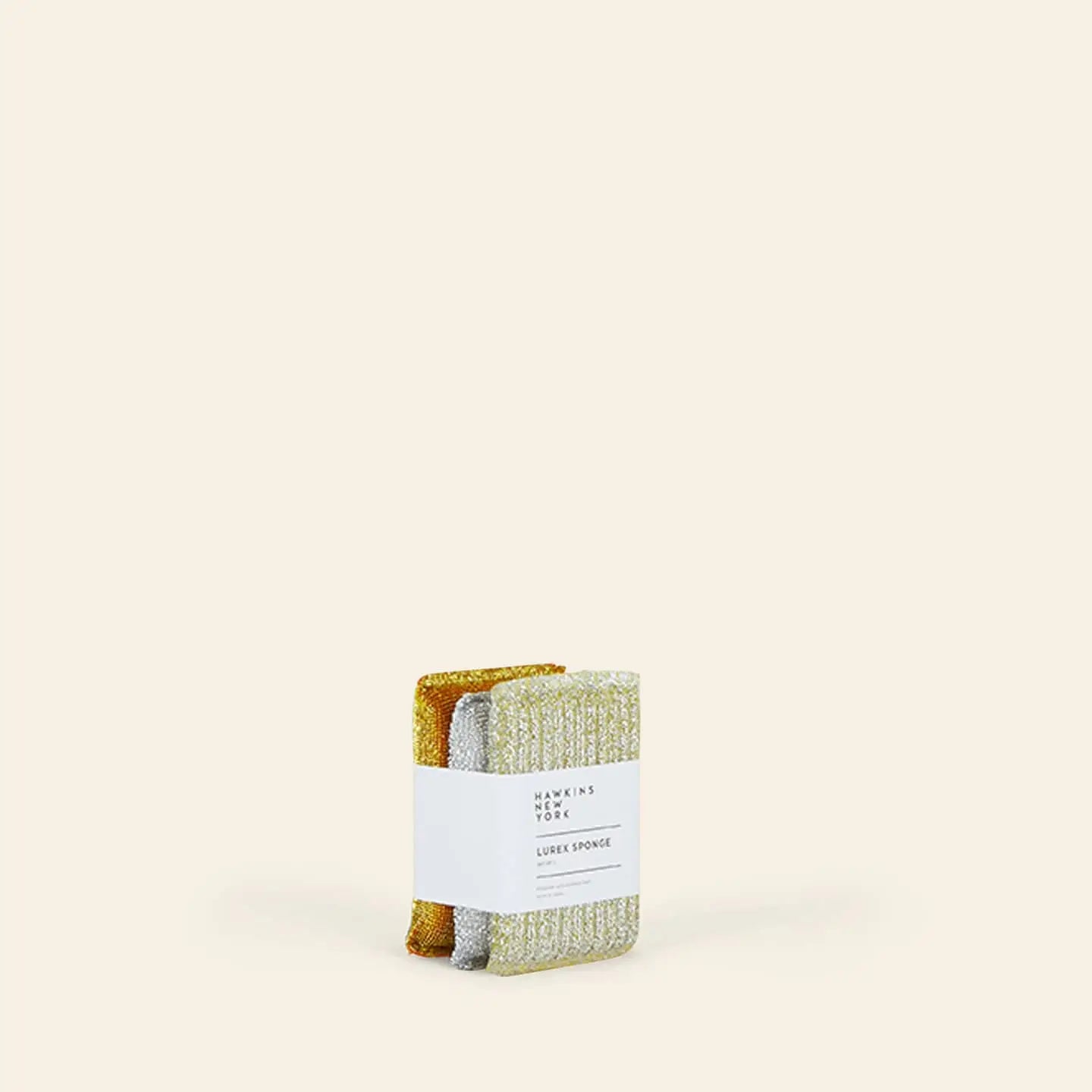 A set of three high-quality Hawkins New York Lurex Sponges, wrapped in a white label, is displayed upright against a plain beige background.