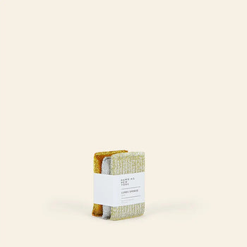 A set of three high-quality Hawkins New York Lurex Sponges, wrapped in a white label, is displayed upright against a plain beige background.