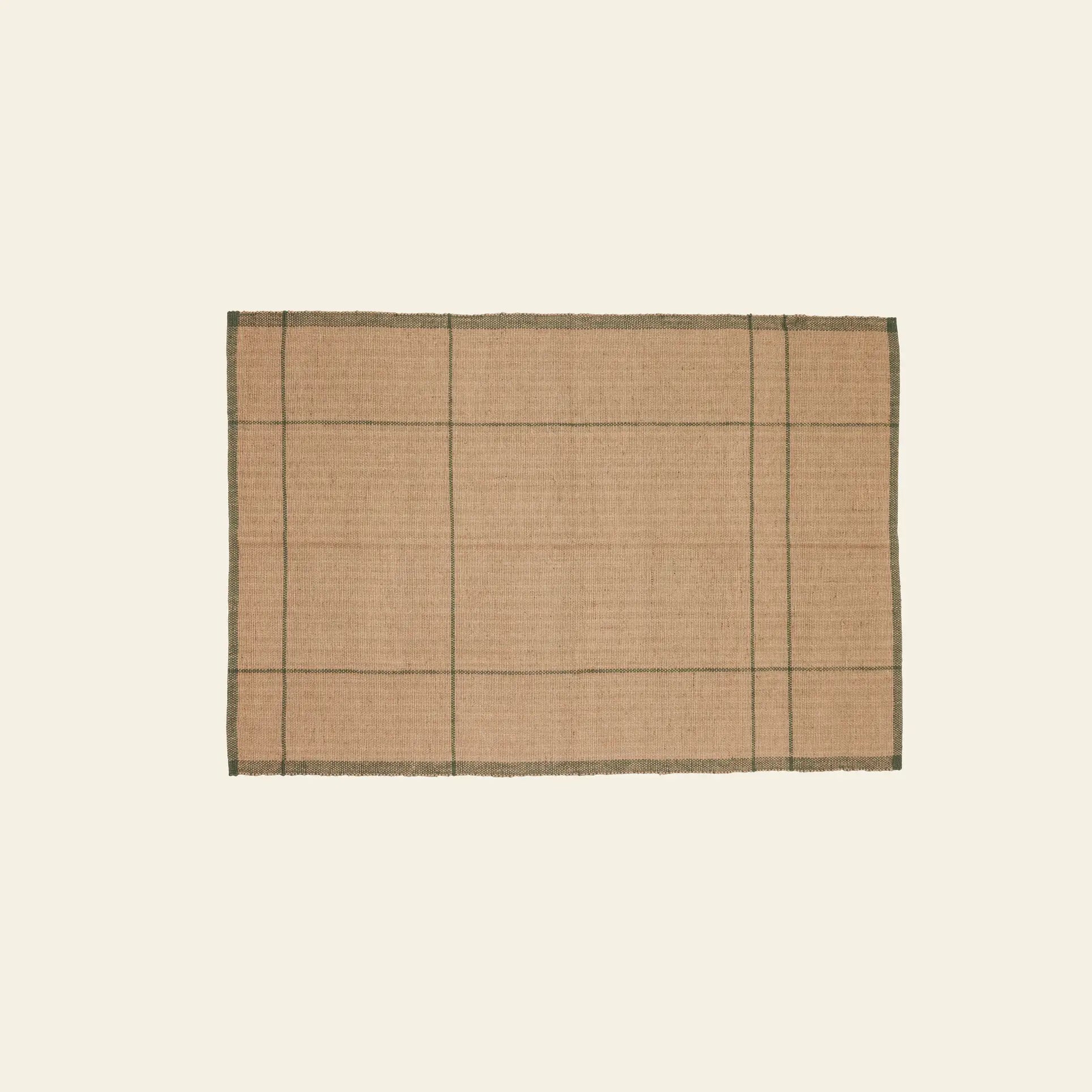 The Hübsch Capri Rug by Hübsch is a rectangular natural tan jute rug with thin dark green grid lines and matching borders. Its soft texture and subtle elegance make it a stylish addition to any space.