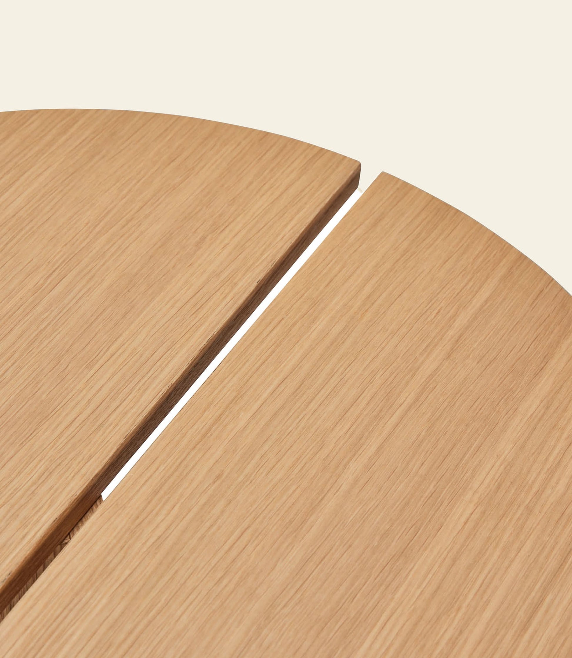 Close-up of two Hübsch Dash Side Table panels by Hübsch, made from FSC-certified wood. The minimalist design features a smooth finish, visible wood grain, and a narrow gap, all set against a beige background.