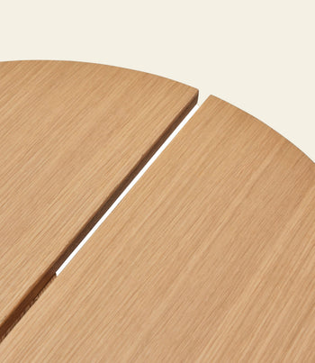 Close-up of two Hübsch Dash Side Table panels by Hübsch, made from FSC-certified wood. The minimalist design features a smooth finish, visible wood grain, and a narrow gap, all set against a beige background.