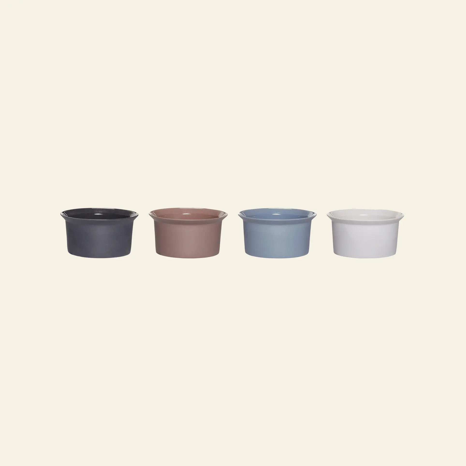 The Hübsch Glacier Bowls, Set of 4 by Hübsch features round porcelain bowls in dark gray, brown, light blue, and white—beautifully arranged for a stylish table setting.