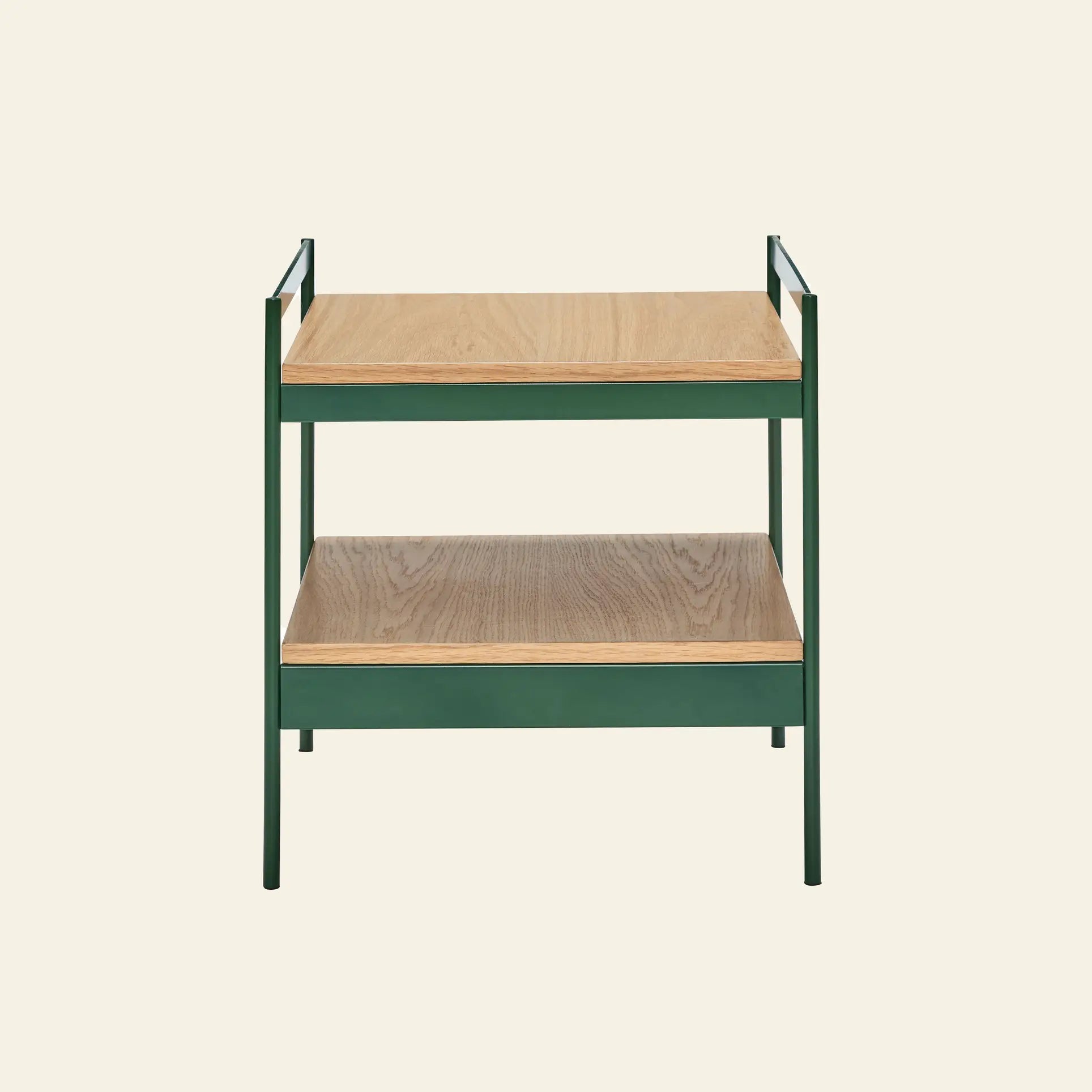 The Hübsch Jaunty Side Table by Hübsch features a green metal frame and two FSC-certified light wood shelves, bringing Nordic style to your space. Shown here against a plain beige background.