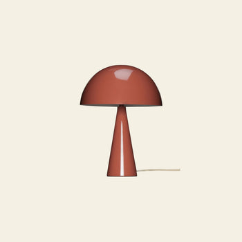 The Hübsch Mush Table Lamp Mini by Hübsch features a glossy reddish-brown, dome-shaped shade and conical base, a white power cord, and comes in multiple colors—perfect for modern homes. Photographed against a plain light background.