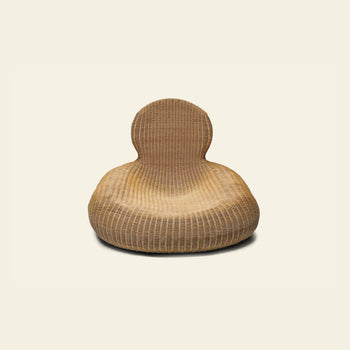 The IKEA Rattan Storvik Lounge Chair by IKEA features a modern, rounded wicker design with a high, curved backrest and seamless contours for comfort and elegance, showcased against a plain light background.