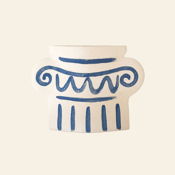 The INI CERAMIQUE Greek Column Ceramic Vase by INI CERAMIQUE is handcrafted, inspired by ancient Greek pottery, and features blue swirls and vertical lines on a light beige background.