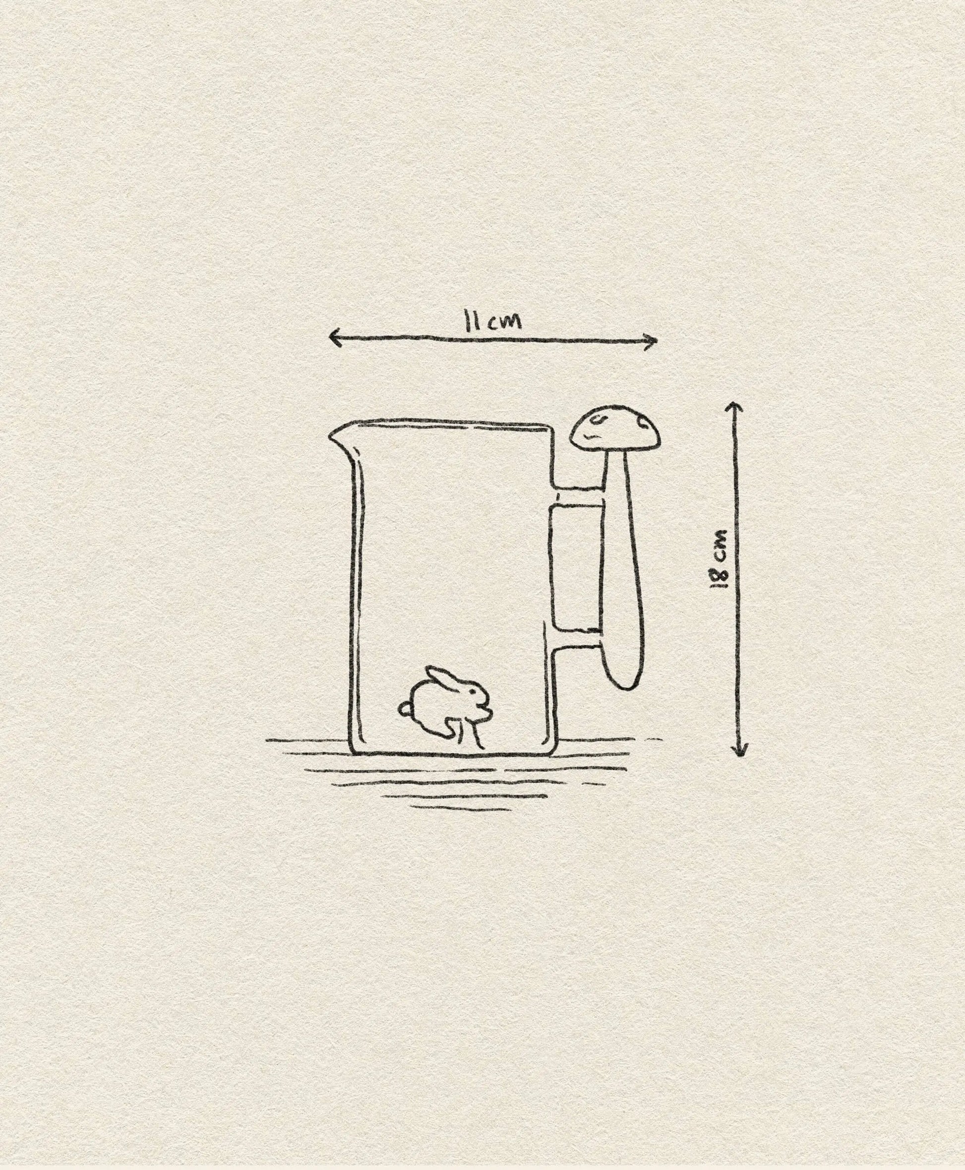 A simple line drawing of the Ichendorf Milano Alice Jug, a handcrafted glass piece from Ichendorf Milano, featuring a mushroom-shaped handle, a small bunny inside, and labeled with dimensions: 11 cm wide and 18 cm tall.