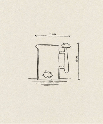 A simple line drawing of the Ichendorf Milano Alice Jug, a handcrafted glass piece from Ichendorf Milano, featuring a mushroom-shaped handle, a small bunny inside, and labeled with dimensions: 11 cm wide and 18 cm tall.