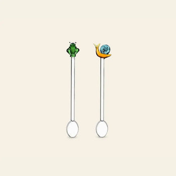 The Ichendorf Milano Animal Farm Spoons, Set of 2, by Ichendorf Milano feature charming green frog and blue-shelled snail figures on the handles, adding playful character to your glassware collection.