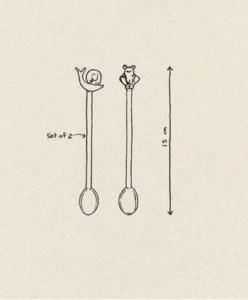 A simple sketch features the Ichendorf Milano Animal Farm Spoons, Set of 2—each 15 cm long, with one snail handle and another with playful animal figures like a frog. An arrow shows their height; “Set of 2” is noted. From Ichendorf Milano.