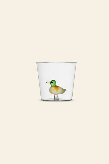 The Ichendorf Milano Animal Farm Tumbler by Ichendorf Milano features a small, colorful glass duck figurine attached to the inside bottom, displayed against a plain beige background.