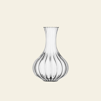 The Ichendorf Milano Bistrot Decanter by Ichendorf Milano features a ribbed, bulbous glass body and a narrow flared neck, crafted with blown glass technique and displayed against a plain light beige background.