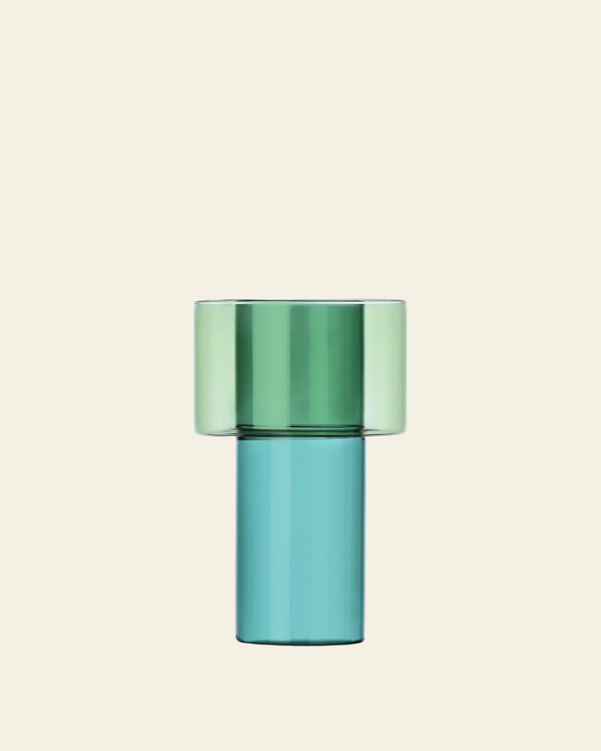 The Ichendorf Milano Boreale Vase A by Ichendorf Milano features modern two-tone borosilicate glass with a wide light green top and tall cylindrical teal blue base—perfect for artistic floral displays against a beige background.