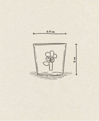 A simple line drawing of a flower in a glass (8 cm tall, 8.5 cm wide) adds nature-inspired charm to the textured off-white background—ideal for the Ichendorf Milano Botanica Tumbler - Lilac by Ichendorf Milano.