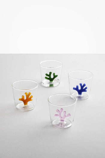 The Ichendorf Milano Coral Reef Tumblers, designed by Alessandra Baldereschi, feature vibrant coral reef-inspired bases in yellow, green, blue, and pink, evoking underwater beauty against clear glass.