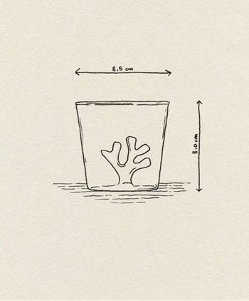 A simple sketch of the Ichendorf Milano Coral Reef Tumbler, featuring a coral reef-inspired design at the bottom. The glass measures 8.5 cm wide by 8.0 cm tall, with dimension arrows shown on a textured light background.